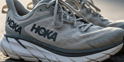 pair of well worn hoka running shoes on a road surface showi 20260331 082202